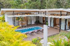 Exterior of Ceiba with private pool and terrace surrounded by tropical greenery in Playa Negra, Puerto Viejo.